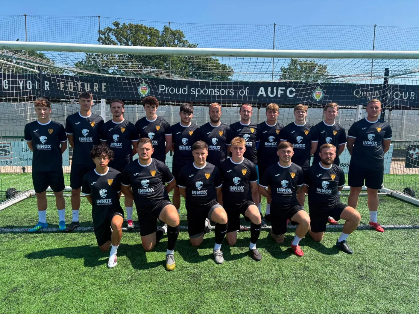 INNOX-sponsored Ashford United FC squad in INNOX Asbestos Services kit